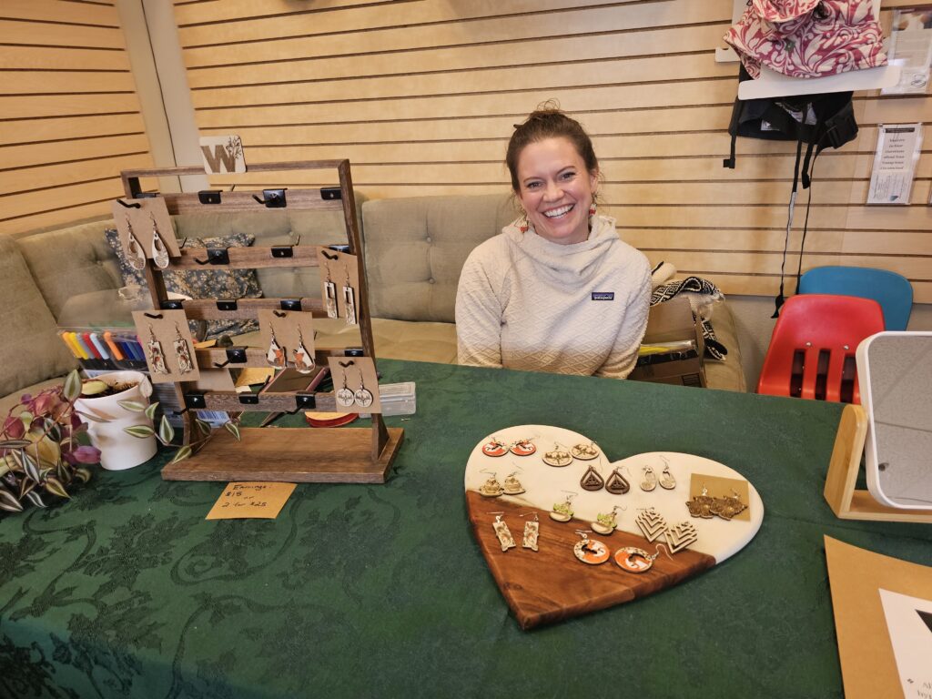 owner at craft fair smiling